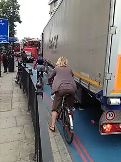 A designated bicycle lane in London, United Kingdom. Here a vehicle has encroached on the bike lane, as there is no hard separation between the road and the lane.