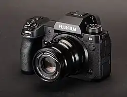 A professional camera on a black background.
