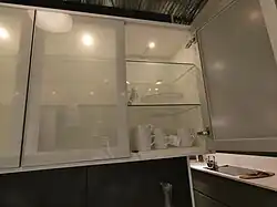 frameless wall cabinet with shelves behind a double door