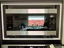 The microwave oven in its position, with the cover frame not installed yet