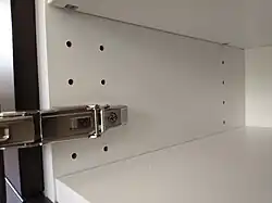 The predrilled holes hold door hinges, too.