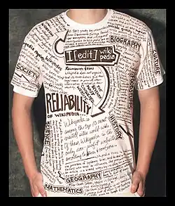 A boy standing in a shirt with wikipedia entries and captions printed all over it.