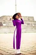 A woman wearing violet Áo dài and Nón lá