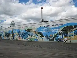 The boardwalk outside the New York Aquarium, with a mural on the aquarium wall
