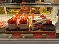Variety of strawberry cake sold in a cake shop