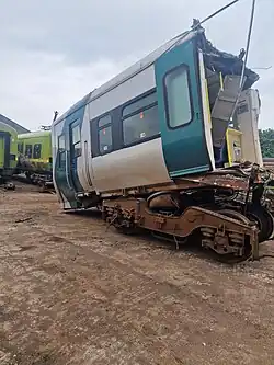 Image of railcar 2718 after two thirds have been cut off and the drivers cab leaning forward on the lead bogie