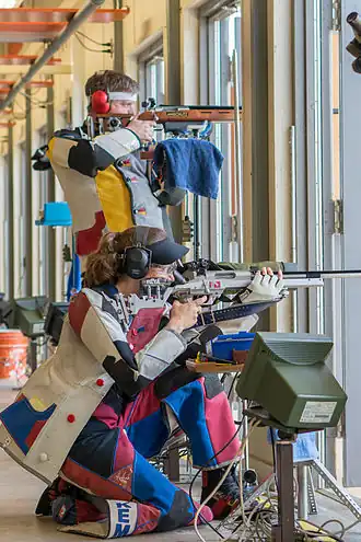 Two shooters during an ISSF 300 meter rifle three positions (prone, kneeling and standing)