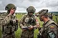 A Spanish soldier shows his armory to Turkish troops at a static display of equipment during the Steadfast Defender 2021 NATO exercise