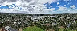 Aerial panorama of Chadstone Shopping Centre with the Dandenong Ranges on the horizon