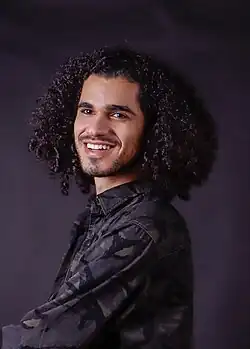 Ali smiling at the camera