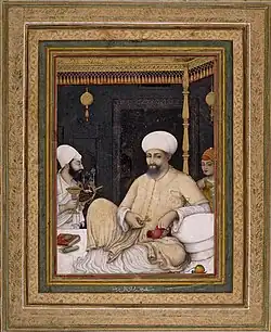Painting of a seated sultan with two other people