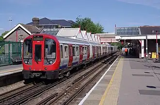Front three-quarter view of a large profile train at Amersham station