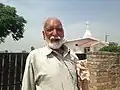 An Indian Christian in front of Methodist Church at Ranbirpura
