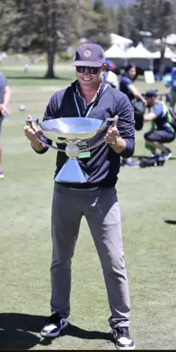Andrew Wantuck holding the FedEx Cup trophy at the 2023 American Century Championship in Lake Tahoe