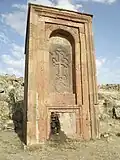 Huge 13th-century khachkar monument located behind the church across the small ravine.