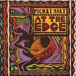 Stylized, colorful drawing of a man, kneeling and playing a large drum