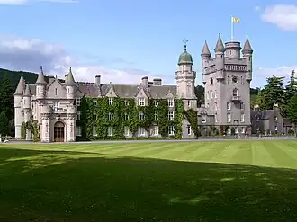Balmoral Castle. The Royal Standard of Scotland flies over it.