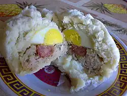 A bánh bao split in half, displaying its contents