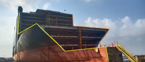 Beached end-of-the-life vessel cut in zig-zag for stability[78] during ship recycling