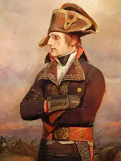 Napoleon Bonaparte, in a dark brown coat, green sash and dark brown pants, looks to the left with a fact of contempt. He has a white and gold hat, and this was painted in the early stages of the campaign.