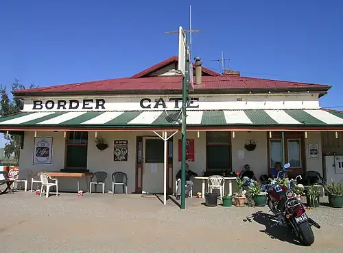 A stone roadhouse, formerly a hotel, with a sign reading "Border Gate roadhouse"
