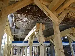 Wooden braces holding up a visibly rusted footbridge