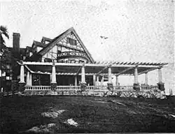 Pergola attached to a large Tudor building
