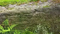 Engraved rock at Adam's Ale spring