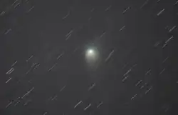 The comet on 28 January 2023, with star trails due to its relative motion in the sky