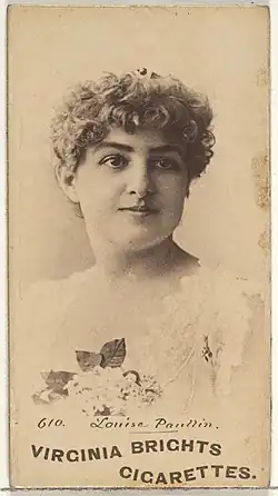 A young white woman with curly hair.