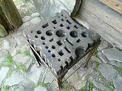 A large Polish swage block, mounted on a pedestal