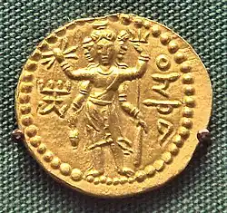 Three-faced four-armed Oesho with attributes, often identified with Shiva, on a coin of Huvishka.[222]