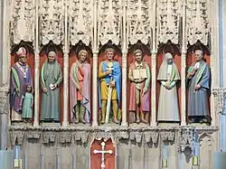 Masonry screen with painted statues