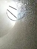 Detail view of pastel tiles and skylight constructed over spiral staircase