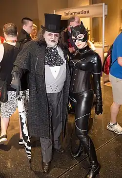 A photograph of cosplayers&nbsp;– a man dressed as the Penguin and a woman dressed as Catwoman