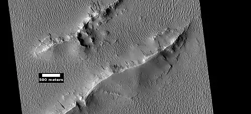Layers and dark slope streaks in Lycus Sulci, as seen by HiRISE under HiWish program