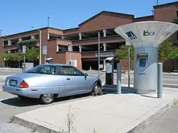 Picture of a silver car charging at a charging station in California.