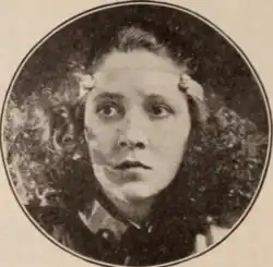 Easter Walters, a young white woman with wavy dark hair, in a circle frame
