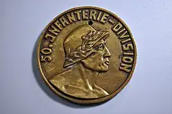 Obverse of a gold-colored commemorative medal for the 50th Infantry Division. A soldier wearing a laurel-fitted helmet is underneath text reading '50.Infanterie-Division'.