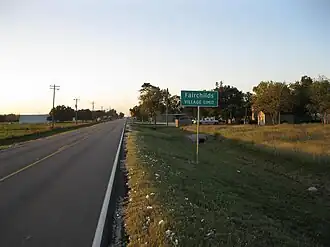 A Fairchilds sign on FM 361 looking northwest. Bits of cotton from the 2012 harvest lie along the roadside.