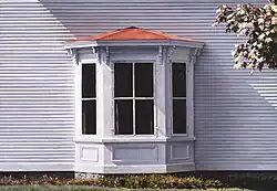 Clapboards around a bay window.
