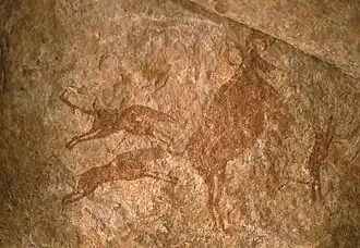 Image 51Petroglyph depicting two dogs hunting – Tassili n'Ajjer, Algeria (from Domestication of the dog)