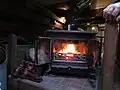 This coal burning stove heats the barge and water.