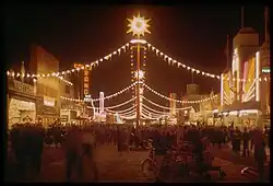 The "Gayway" at the Golden Gate International Exhibition, photographed here at night in 1940 by Charles Cushman, hosted numerous sideshow-style attractions, including "Sally Rand's Nude Ranch" (neon sign, at left), a burlesque show.