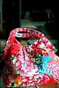 A modern handbag in a traditional Hakka Chinese-style floral fabric design