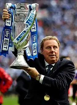 Harry Redknapp lifts the Sky Bet play-off final trophy designed and made by Thomas Lyte