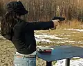 A woman plinking with a Hi-Point pistol in .40 S&W in Alaska