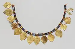 Headdress; 2600–2500 BC; gold (the leaves), lapis lazuli (the blue beads) and carnelian (the orange beads); length: 38.5&nbsp;cm; Metropolitan Museum of Art