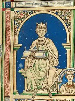 A medieval illuminated manuscript illustration shows a crowned king seated on a throne within an ornate architectural frame. He wears a long, flowing robe decorated with small red dots and holds a model of a church or chapel in his lap. The background is a rich blue, scattered with white stars. The style is typical of 12th- or 13th-century Western European manuscript art.