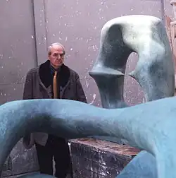 Henry Moore in his studio surrounded by sculptures